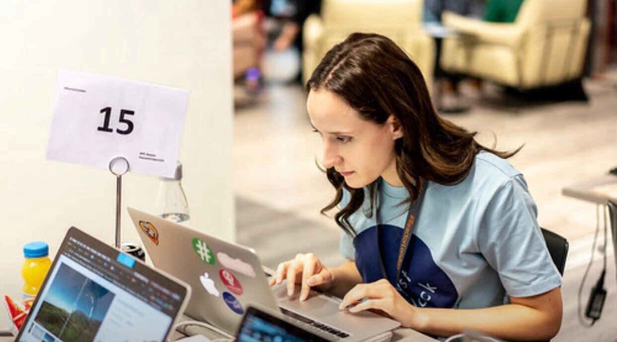 Me at CatalystHack, coding on my laptop